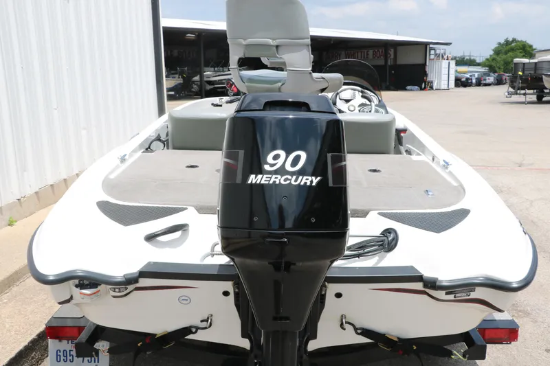 Slide: The Image of 2009 Triton 17 Explorer boat with 90 Mercury outboard motor, docked outdoors. - 5