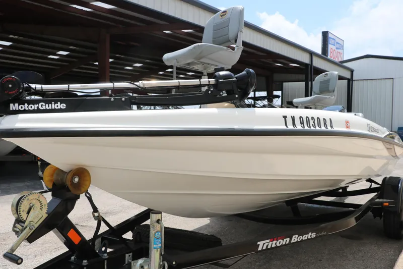 Slide: The Image of 2009 Triton 17 Explorer boat on trailer, featuring MotorGuide trolling motor. - 9