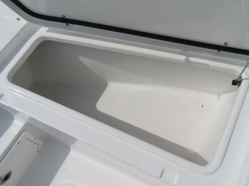 Slide: The Image of 2025 Sea Hunt Gamefish 25 storage compartment, open and empty, showcasing interior space. - 13