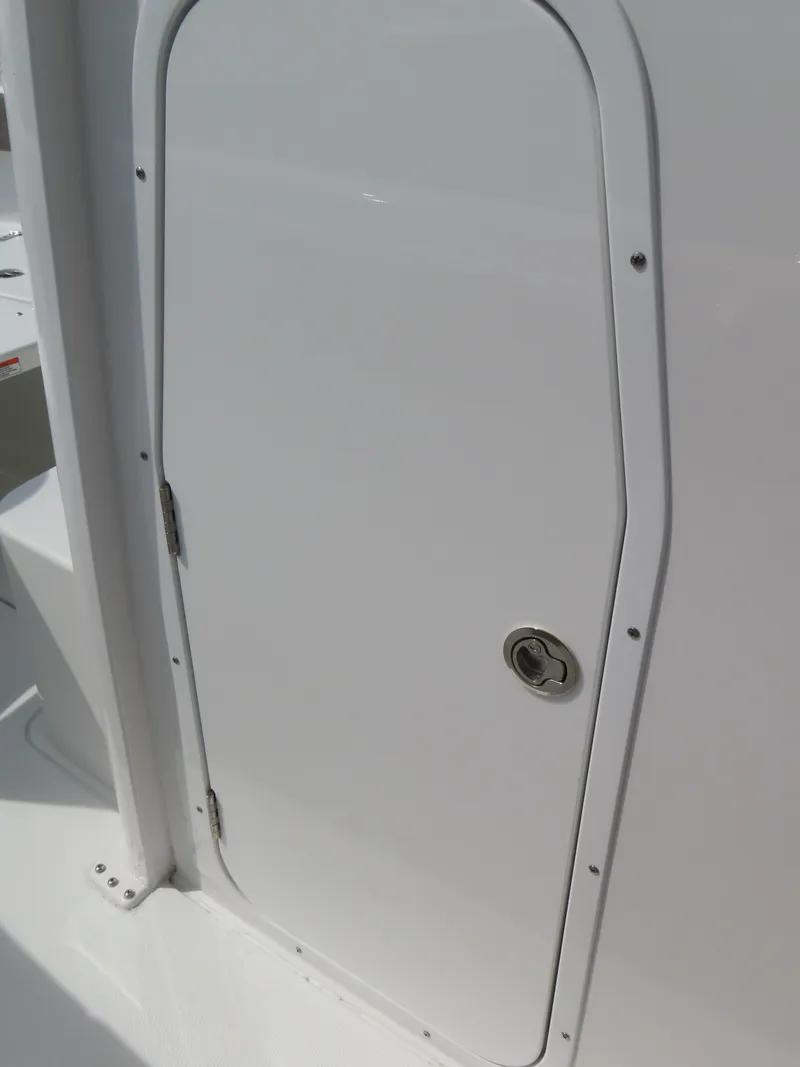 Slide: The Image of 2025 Sea Hunt Gamefish 25 boat compartment door, white finish, stainless steel handle. - 20