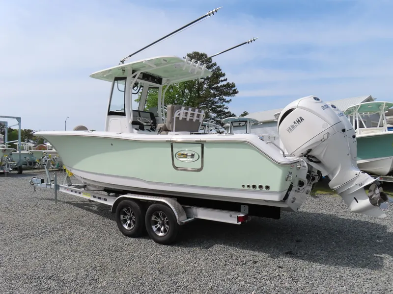 Slide: The Image of 2025 Sea Hunt Gamefish 25 boat on trailer, featuring dual engines and sleek design. - 3