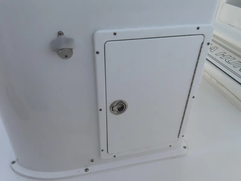 Slide: The Image of 2025 Sea Hunt Gamefish 25 boat storage compartment with secure latch. - 31