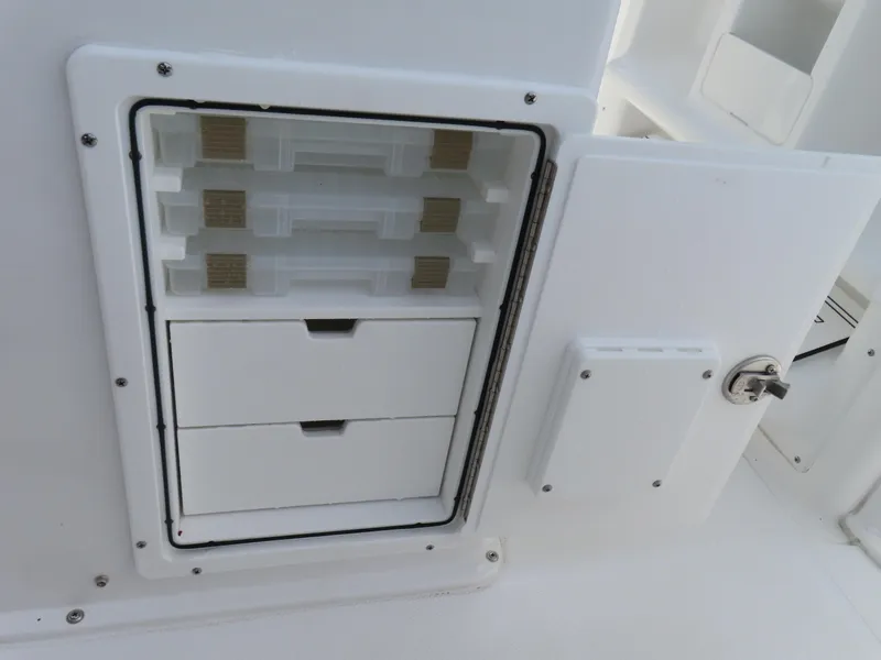 Slide: The Image of 2025 Sea Hunt Gamefish 25 storage compartment with drawers and tackle boxes. - 32