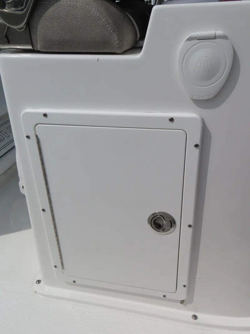 Slide: The Image of 2025 Sea Hunt Gamefish 25 boat storage compartment with secure latch. - 33