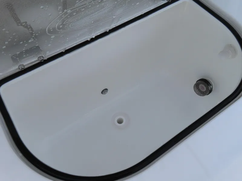 Slide: The Image of Livewell compartment of 2025 Sea Hunt Gamefish 25 boat, featuring drainage and aeration systems. - 36