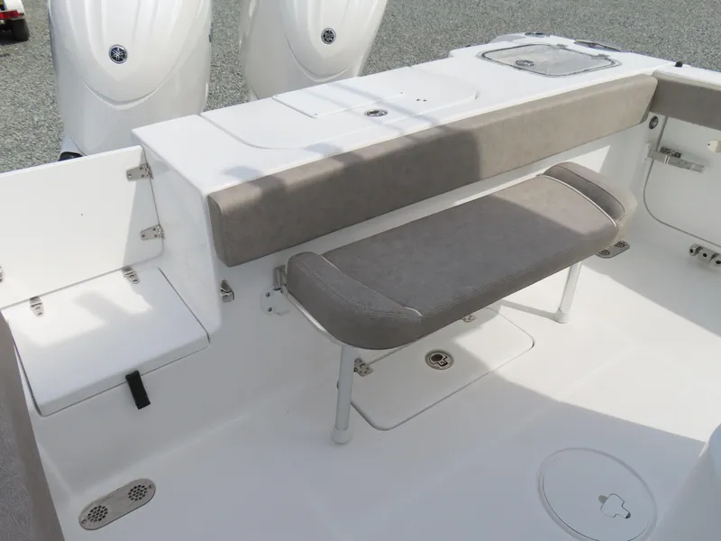 Slide: The Image of 2025 Sea Hunt Gamefish 25 boat interior with cushioned seating and dual outboard motors. - 37