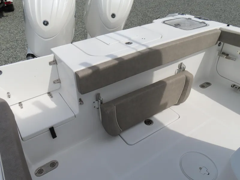 Slide: The Image of 2025 Sea Hunt Gamefish 25 boat interior with cushioned seating and dual engines. - 38