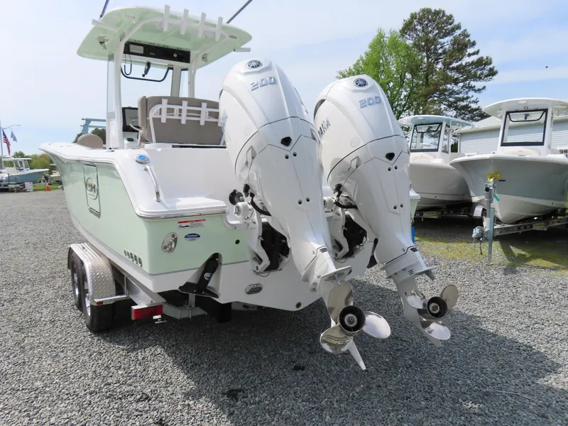 Slide: The Image of 2025 Sea Hunt Gamefish 25 boat with dual Yamaha engines on a trailer. - 4