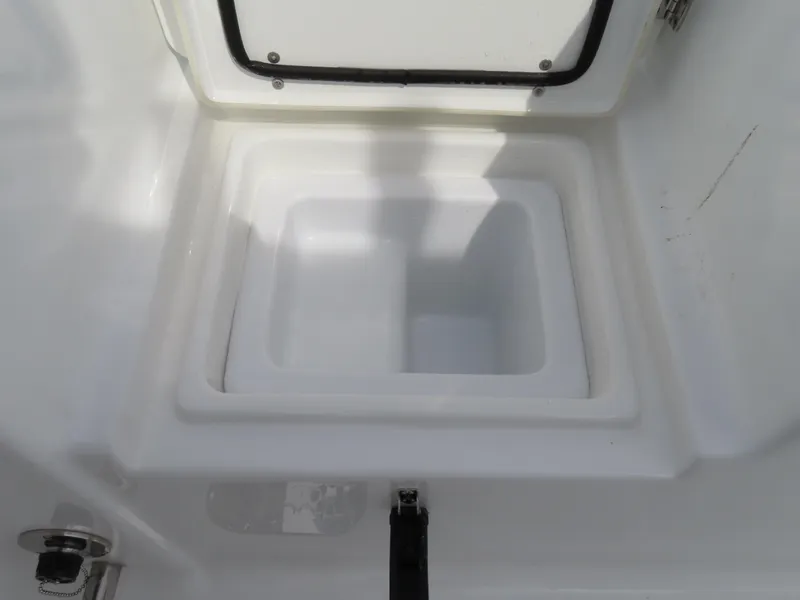 Slide: The Image of 2025 Sea Hunt Gamefish 25 boat storage compartment, open lid, white interior. - 40