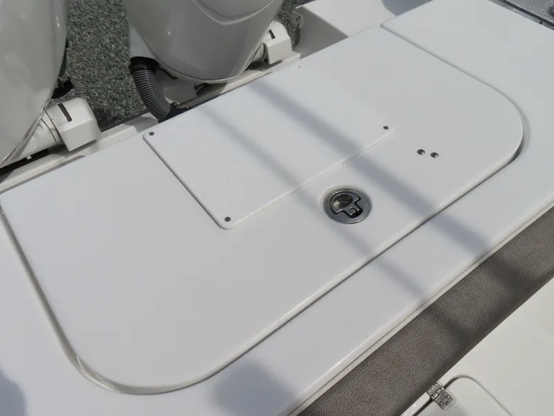 Slide: The Image of 2025 Sea Hunt Gamefish 25 boat deck with storage compartment and engine details. - 41