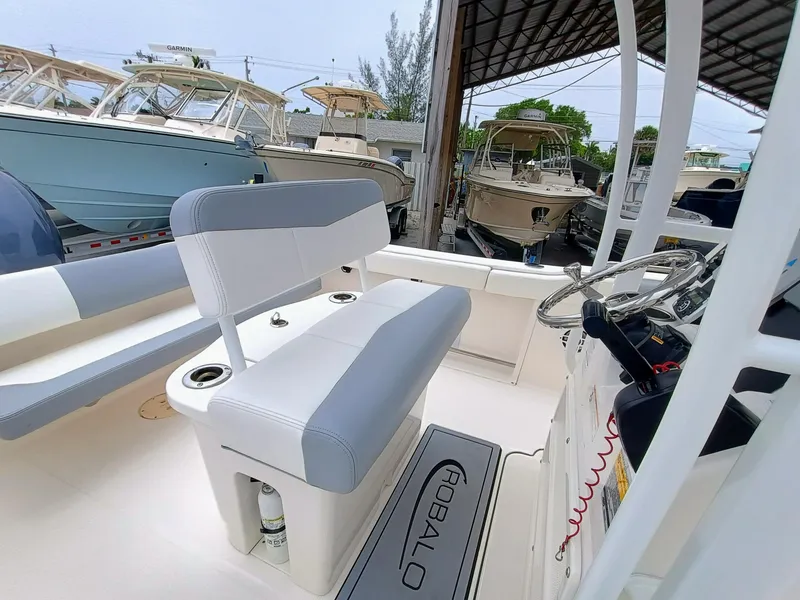 Slide: The Image of 2023 Robalo R222 Center Console boat interior with seating and steering wheel. - 13