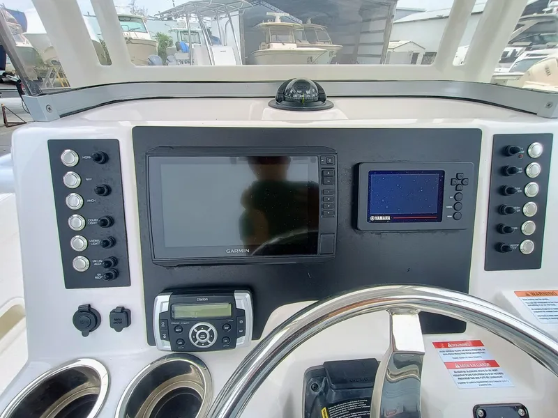 Slide: The Image of 2023 Robalo R222 Center Console dashboard with navigation screens and controls. - 15