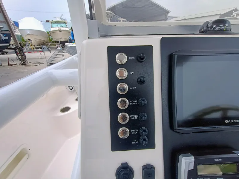 Slide: The Image of 2023 Robalo R222 Center Console dashboard with control panel and Garmin display. - 17