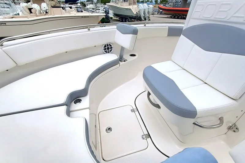 Slide: The Image of 2023 Robalo R222 Center Console boat interior with cushioned seating and storage compartments. - 21