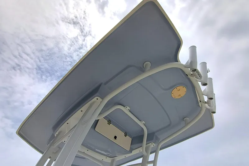 Slide: The Image of 2023 Robalo R222 Center Console T-top against cloudy sky. - 22