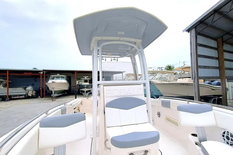 Slide: The Image of 2023 Robalo R222 Center Console boat in a marina storage area. - 23