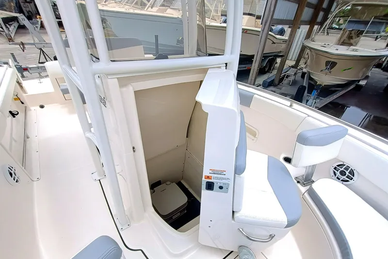 Slide: The Image of 2023 Robalo R222 Center Console boat interior with seating and storage area. - 24