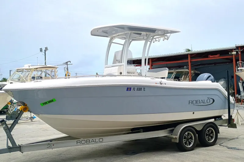 Slide: The Image of 2023 Robalo R222 Center Console boat on trailer, displayed outdoors. - 4