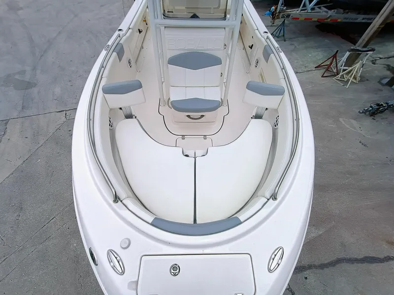 Slide: The Image of 2023 Robalo R222 Center Console boat interior with cushioned seating and storage compartments. - 5