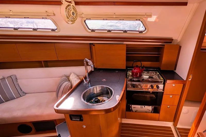 Slide: The Image of Interior of 2014 Hanse 325 yacht with kitchen, sink, stove, and seating area. - 19
