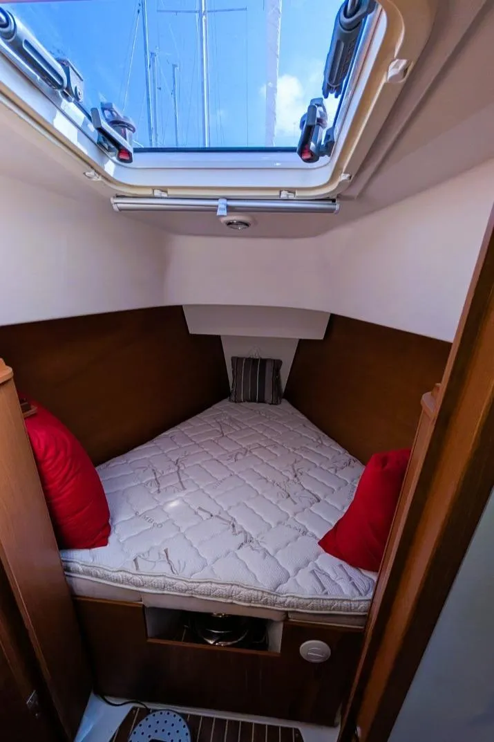 Slide: The Image of Cozy cabin interior of 2014 Hanse 325 sailboat with skylight and red pillows. - 23
