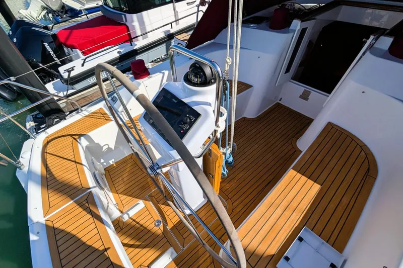 Slide: The Image of Steering wheel and cockpit of 2014 Hanse 325 sailboat with wooden deck. - 24