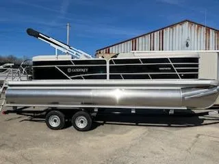 The Image of 2023 Sweetwater 2286SBX pontoon boat on trailer, parked outdoors. - 0