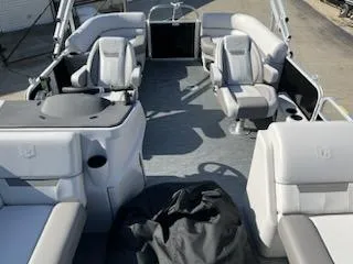 Slide: The Image of 2023 Sweetwater 2286SBX pontoon boat interior with plush seating and modern design. - 3