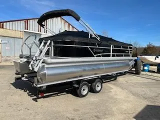 Slide: The Image of 2023 Sweetwater 2286SBX pontoon boat on trailer, parked outdoors. - 9