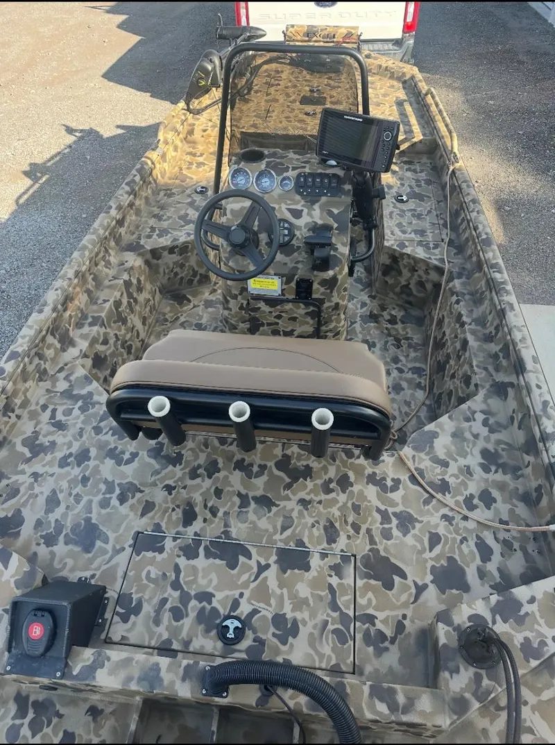 Slide: The Image of 2025 Excel 1860 F4 Shallow Water Pro Console boat with camouflage design and advanced controls. - 12