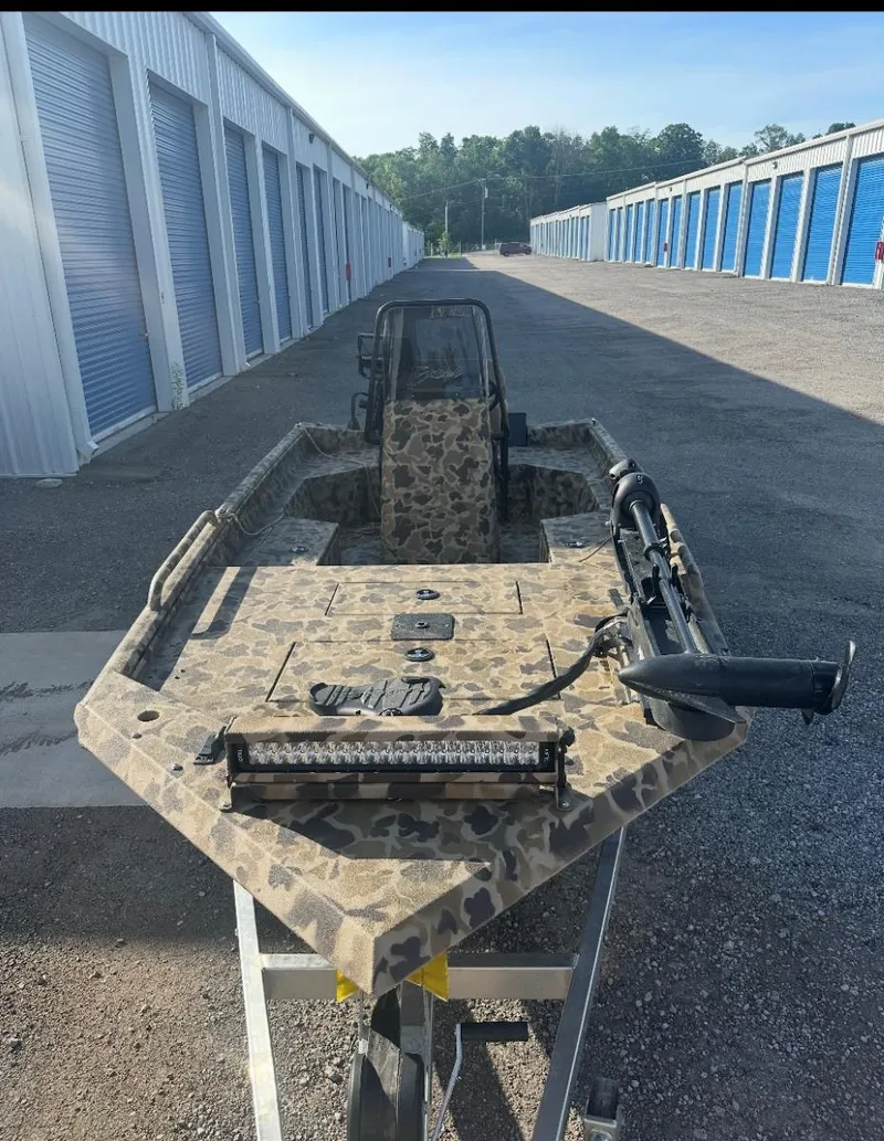 Slide: The Image of 2025 Excel 1860 F4 Shallow Water Pro Console boat in storage facility. - 9