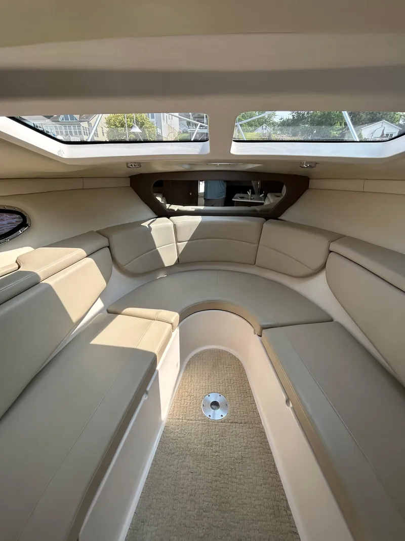 Slide: The Image of 2017 Regal 30 Express cabin interior with beige seating and natural light. - 11