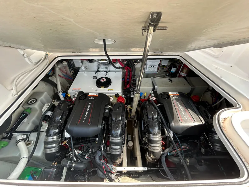 Slide: The Image of Engine compartment of a 2017 Regal 30 Express boat, featuring dual Volvo Penta engines. - 13