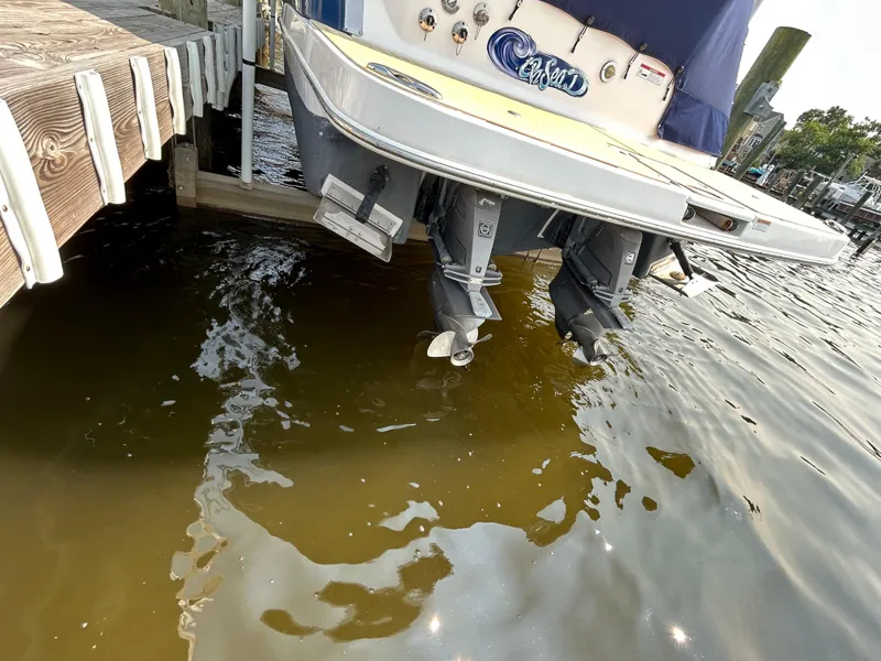 Slide: The Image of 2017 Regal 30 Express boat stern with dual propellers near dock. - 14