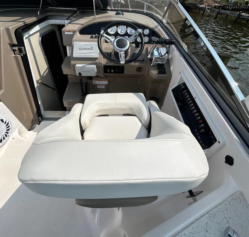 Slide: The Image of 2017 Regal 30 Express boat cockpit with steering wheel and Garmin navigation system. - 6