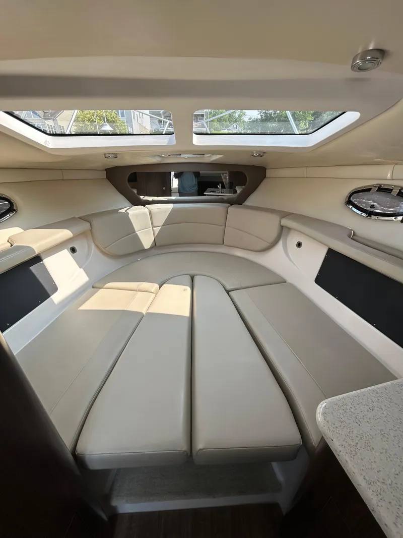 Slide: The Image of 2017 Regal 30 Express cabin interior with beige seating and large windows. - 8