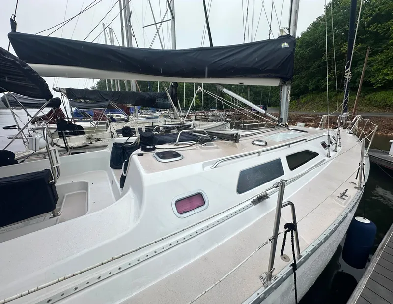 Slide: The Image of 1998 Catalina 400 sailboat docked, featuring sleek design and spacious deck. - 2