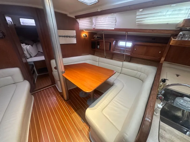 Slide: The Image of Interior of a 1998 Catalina 400 sailboat with cozy seating and wooden finishes. - 20