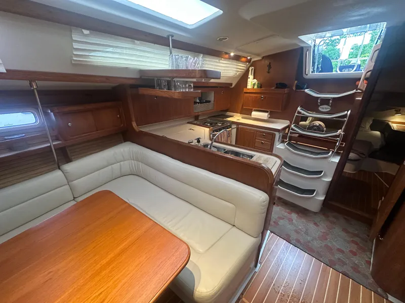 Slide: The Image of Interior of a 1998 Catalina 400 sailboat with kitchen and dining area. - 22
