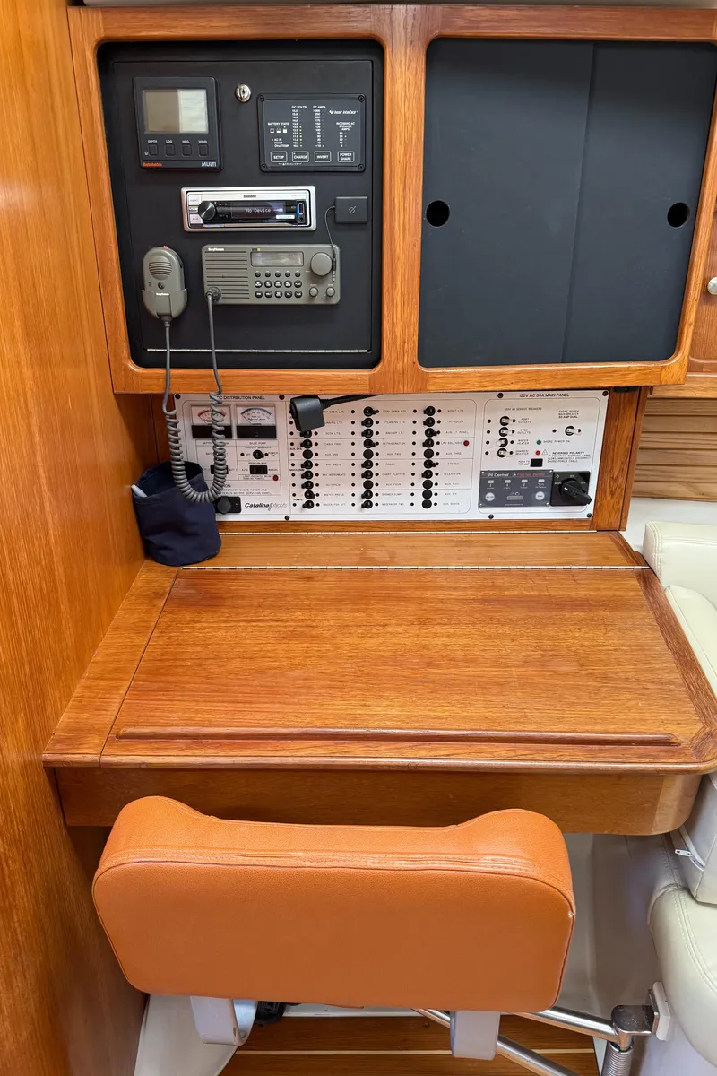 Slide: The Image of Navigation station of a 1998 Catalina 400 yacht with control panels and communication equipment. - 24