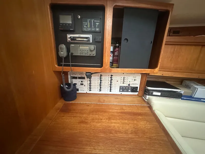 Slide: The Image of Control panel inside a 1998 Catalina 400 sailboat, featuring communication and navigation equipment. - 26