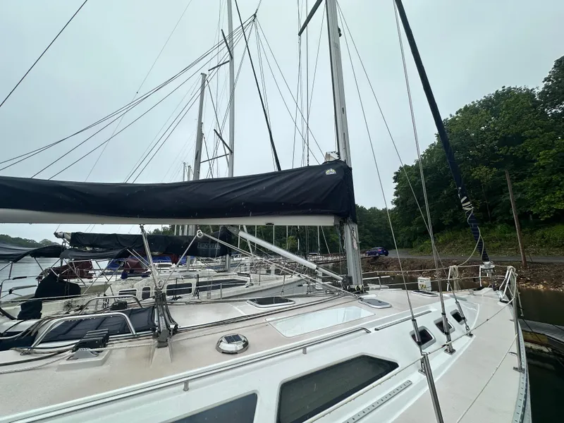 Slide: The Image of Sailboat Catalina 400, 1998 model, docked with forested shoreline in background. - 3