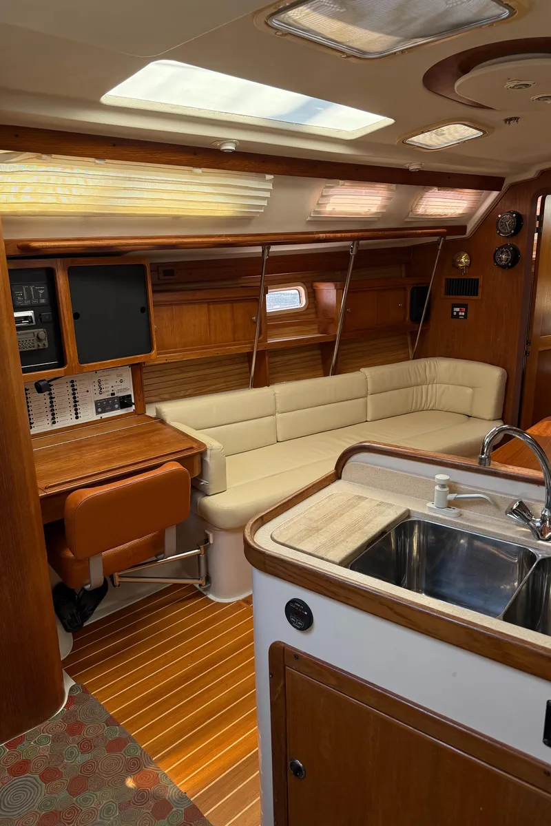 Slide: The Image of Interior of a 1998 Catalina 400 yacht with wooden finishes and a cozy seating area. - 30