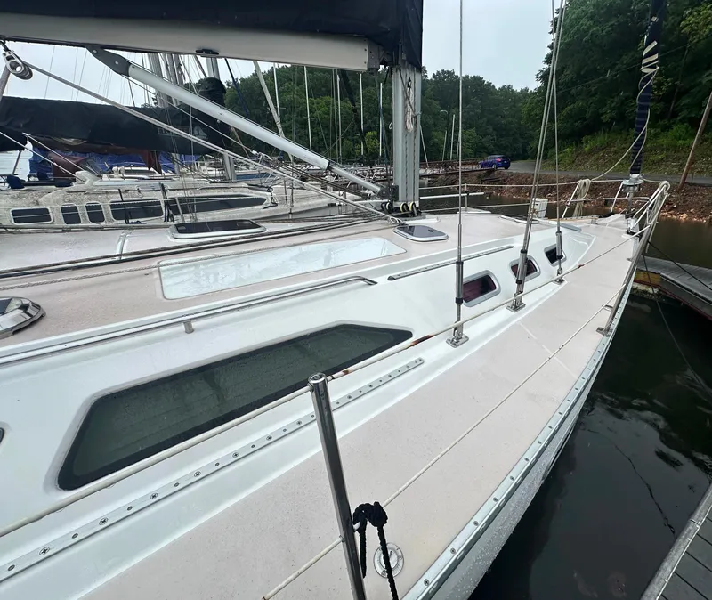 Slide: The Image of Catalina 400 sailboat from 1998 docked, showcasing sleek deck design and rigging. - 4