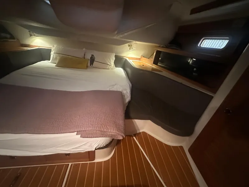 Slide: The Image of Cozy cabin interior of a 1998 Catalina 400 sailboat with a neatly made bed. - 43