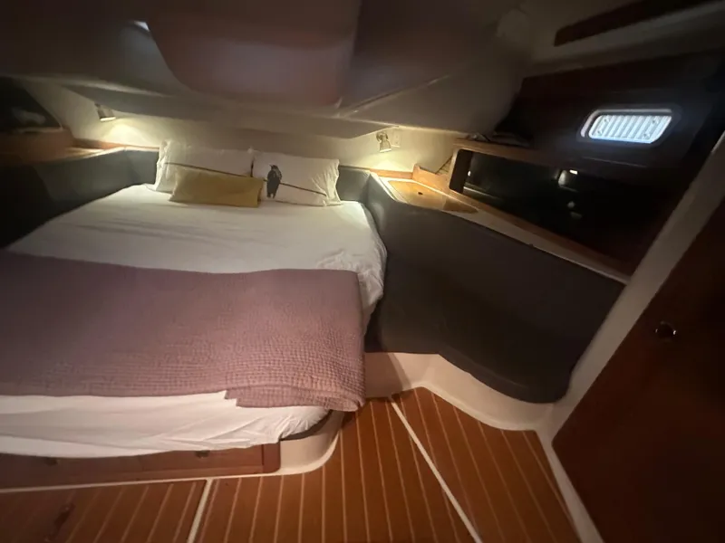 Slide: The Image of Cozy cabin interior of a 1998 Catalina 400 sailboat with a neatly made bed. - 44