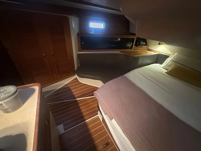 Slide: The Image of Cozy cabin interior of a 1998 Catalina 400 sailboat with wooden flooring and bed. - 45