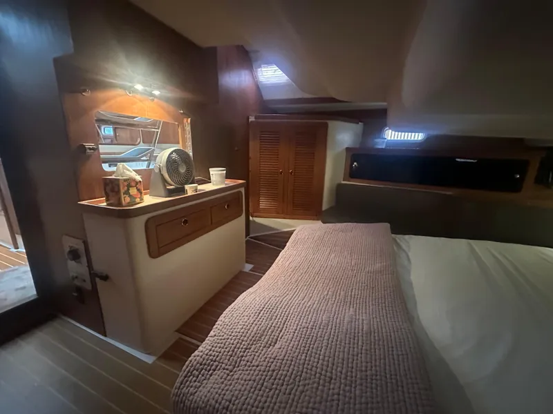 Slide: The Image of Cozy interior of a 1998 Catalina 400 yacht with bed and wooden cabinetry. - 46