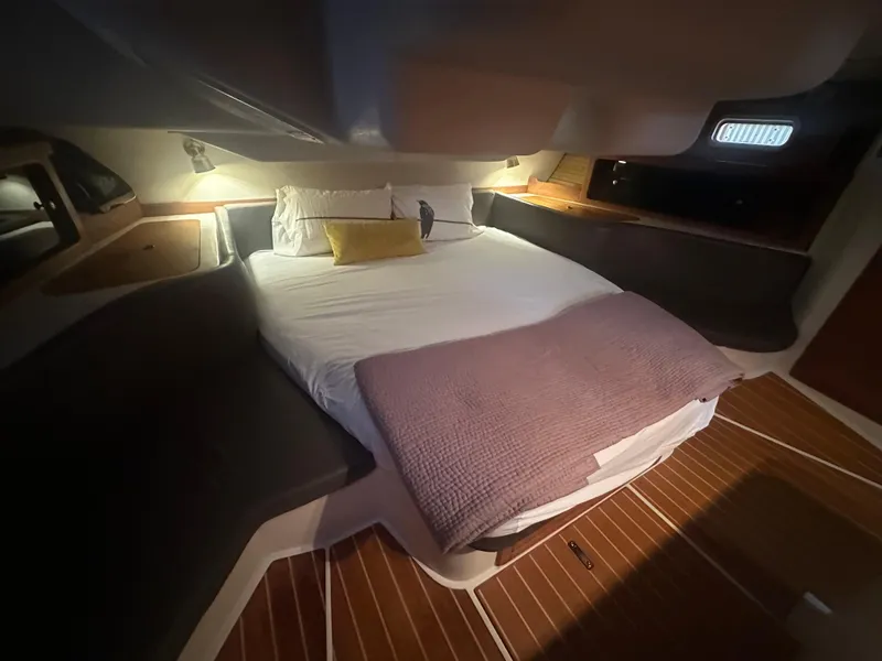 Slide: The Image of Cozy cabin interior of a 1998 Catalina 400 sailboat with a neatly made bed. - 48
