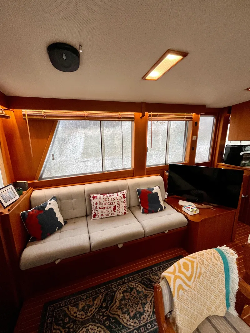 Slide: The Image of Interior of a 1997 Grand Banks 49 Classic yacht with cozy seating and decor. - 13